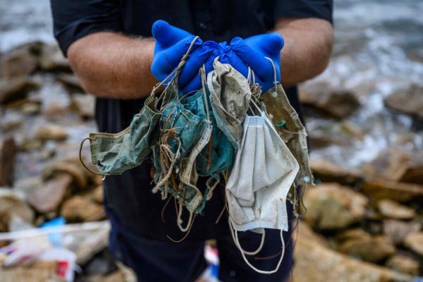 Gary Stokes, founder of the environmental group Oceans Asia, displays discarded face masks found on a beach on the outlying Lantau island in Hong Kong